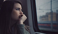 Young woman sitting in a train staring out the window. Image by StockSnap from Pixabay.&nbsp;